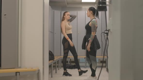 Wide Shot of Sportive Athletic Women Talking in Gym Locker Room After Training. Portrait of