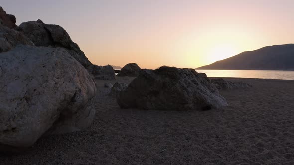 Sunset on Tropical Coast with Rocks and Wavy Ocean