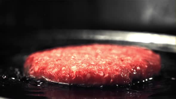 Super Slow Moving Raw Burger is Fried with Oil Splashes and Hot Steam