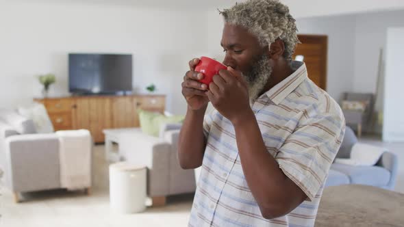 Senior man drinking coffee at home