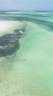 Vertical Video Kitesurfing Near the Shore of Zanzibar Tanzania