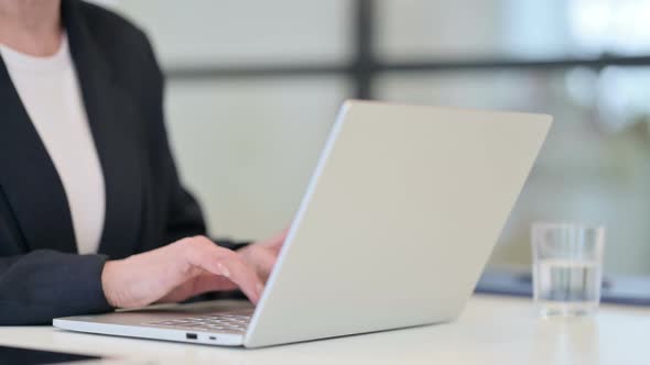 Old Businesswoman Typing on Laptop Close Up