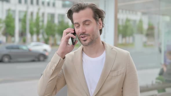 Young Man Talking on Phone While Standing Outdoor