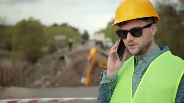 Portrait of Young Man Working Speaking By Phone