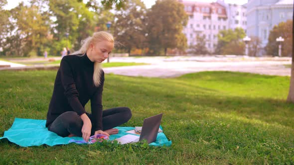 Busy Girl Works and Eats Outdoors