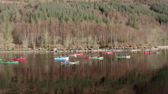 A Team of Canoeists Traversing a Lake in the Early Morning