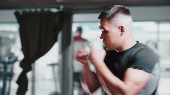 Young Man in Sports Clothes Performing Shadow Boxing in the Gym