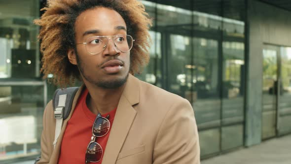 Young Black Businessman Riding E-Scooter in City