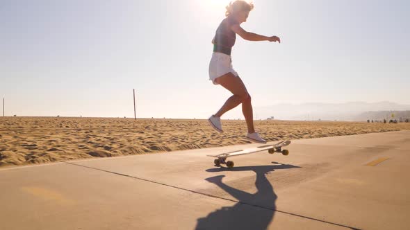 Woman Skater Doing No Comply Skateboarding Trick At Skatepark. full shot, slow motion