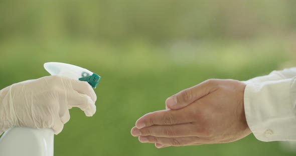 Disinfecting Hands With Spray