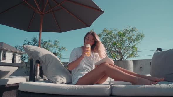 Pretty Woman Drinking Cocktail at Poolside