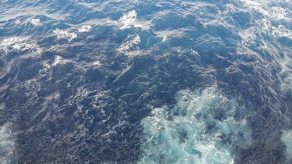 Sea water to the sides of a cruiser while navigating. Effects from the engines propulsion can be see