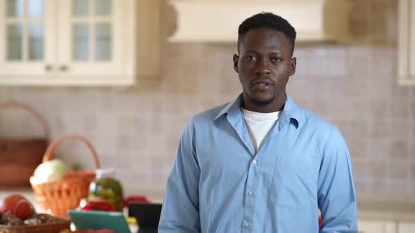 Proud African American Man Hanging Apron on Shoulder Looking at Camera Smiling