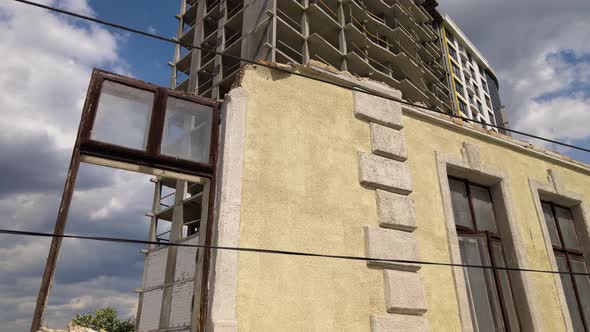 Architectural Detail of High Frame of Monolithic Concrete Building Under Construction and Old