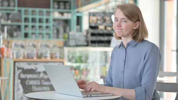 Young Woman with Laptop Shaking Head As No Sign