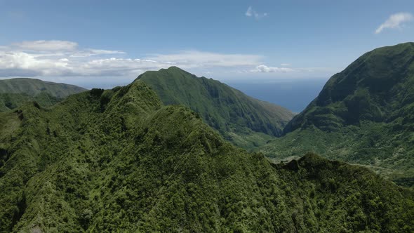 Drone panoramic shot of Pacific Ocean and mountain range on Maui, Hawaii, USA