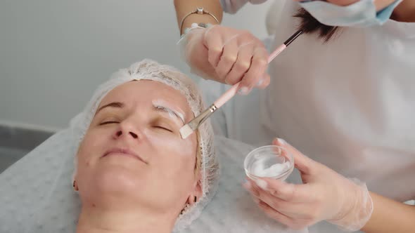 the Beautician Performs a Facelift Procedure