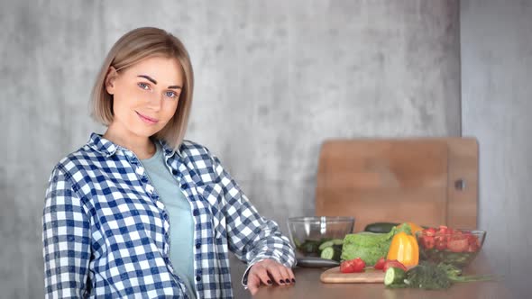 Portrait of Beautiful Casual Girl Posing at Modern Kitchen During Cooking Medium Closeup