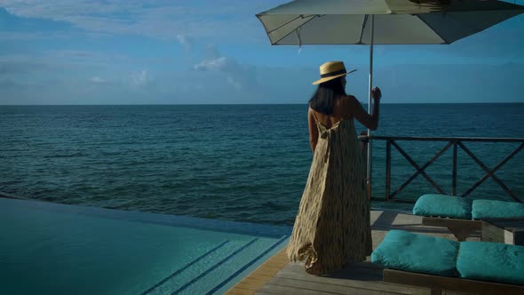 Curacao Couple on Vacation in Curacao Watching Sunset By the Pool