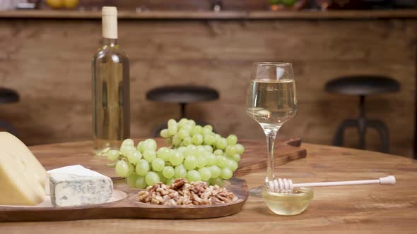 Slider Move Revealing a Collection of Different Cheeses on a Wooden Tray