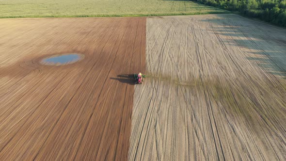 Tractor Plows And Seeder Plants Seeds Of Grain Crops In Rural Field Aerial