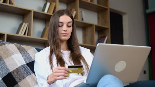 Woman Consumer Paying for Purchase in Web Store Using Laptop Technology