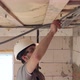 Male builder in the process of installing corrugated cable. - VideoHive Item for Sale