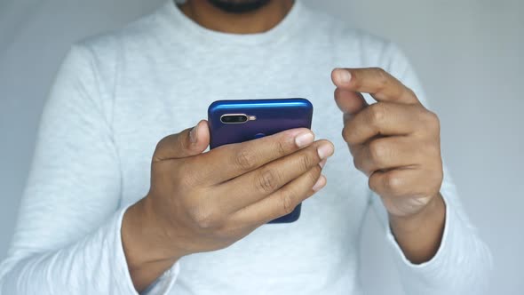 Close Up of Young Man Hand Using Smart Phone