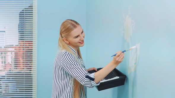 Woman Painting Flowers on the Wall.