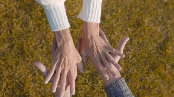 Top View of Senior Couple Holding Hands Relaxing Outdoors