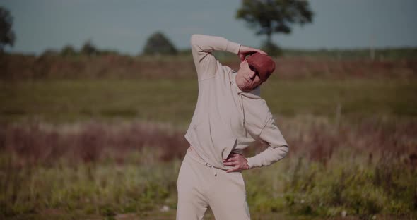 Senior Man Exercising Outdoors in Autumn Sunny Day