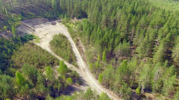 Aerial view of a former gravel pit and beautiful coniferous forest in summer, Finland July 2018.