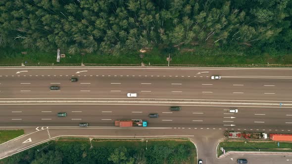 Traffic of Cars and Trucks on the Sixlane Freeway in Summer Day  Top View Shot