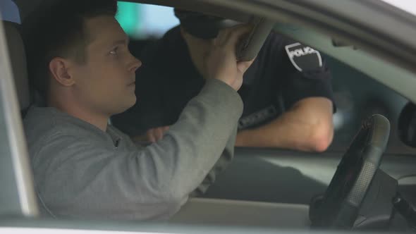 Suspicious Male Driver Giving Documents to Policeman, Traffic Controls, Law