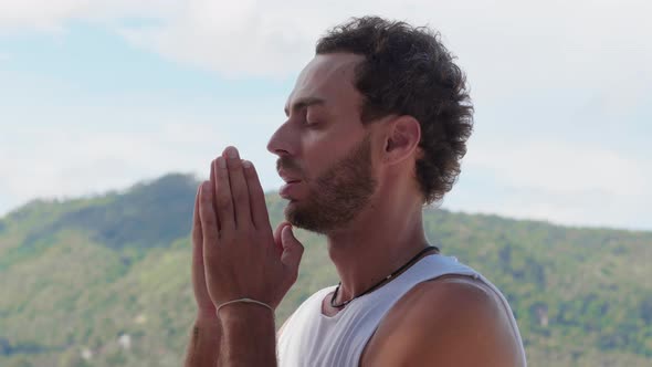Peaceful Bearded Man Quietly Says the Prayer Looks Upward at Beautiful Sky with Hope While Praying