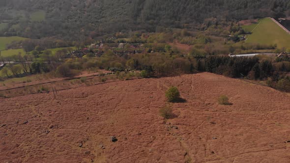 Drone travelling backwards from a Peak in the Peak District while panning up from Bamford Edge Alter