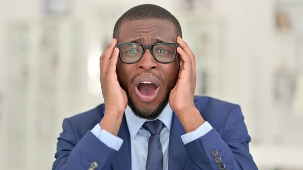 Portrait of Upset African Businessman Reacting To Loss, Failure 