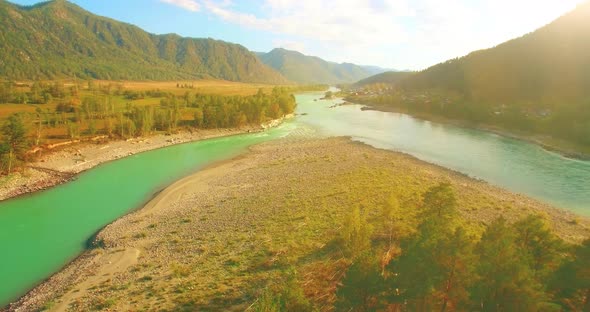 Low Altitude Flight Over Fresh Fast Mountain River with Rocks at Sunny Summer Morning