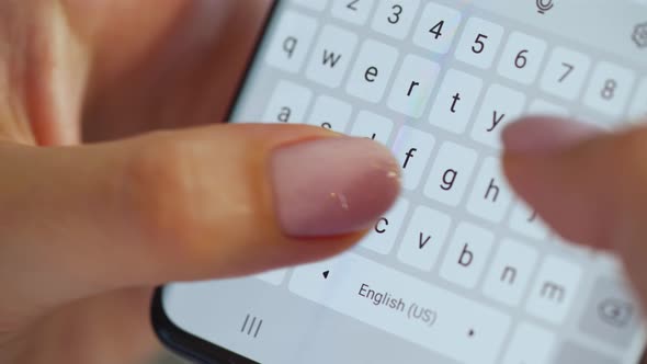 Hands Typing Text on Smartphone Close-up