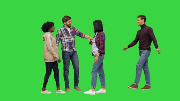 Four Young Friends Meeting in the Street Full Size Video on a Green Screen Chroma Key
