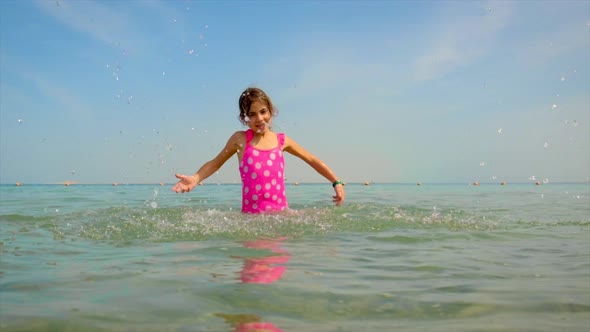 A Child Splashes Water on the Sea