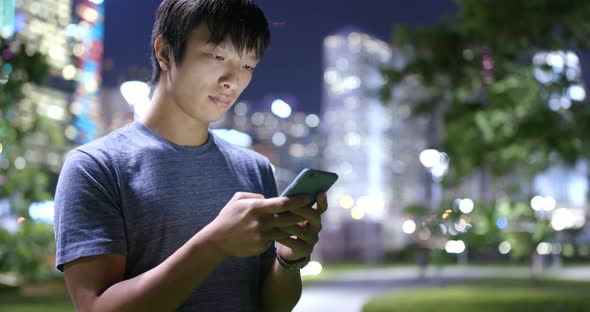 Man use of mobile phone at night 