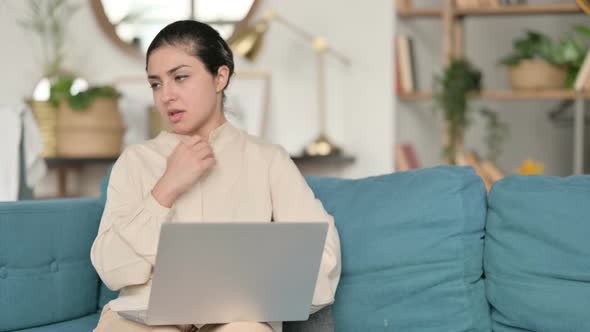 Indian Woman with Laptop Coughing on Sofa 