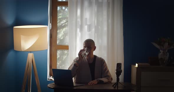 Young Woman Using Laptop Studying at Home