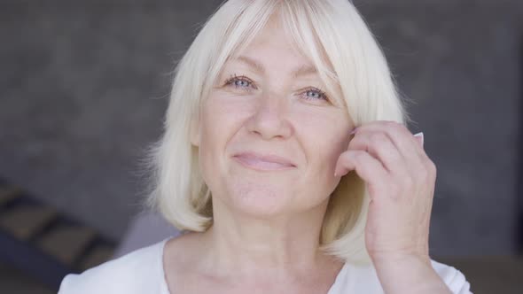 Attractive Mature Woman Looking at the Camera and Smiling