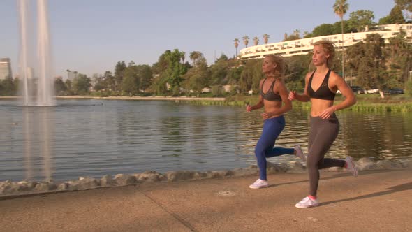 Athletic Twins Running In The Park Slow-Motion