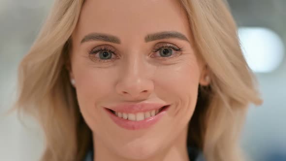 Close Up of Face of Young Woman Smiling at Camera