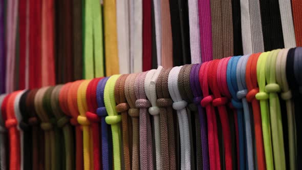 Lots of Multicolored Textile Ropes Hang in Several Rows