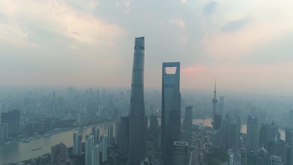 Aerial view of Shanghai skyline at sunset with mist, China.