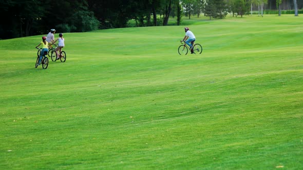 Young People Riding Bicycles Outdoors